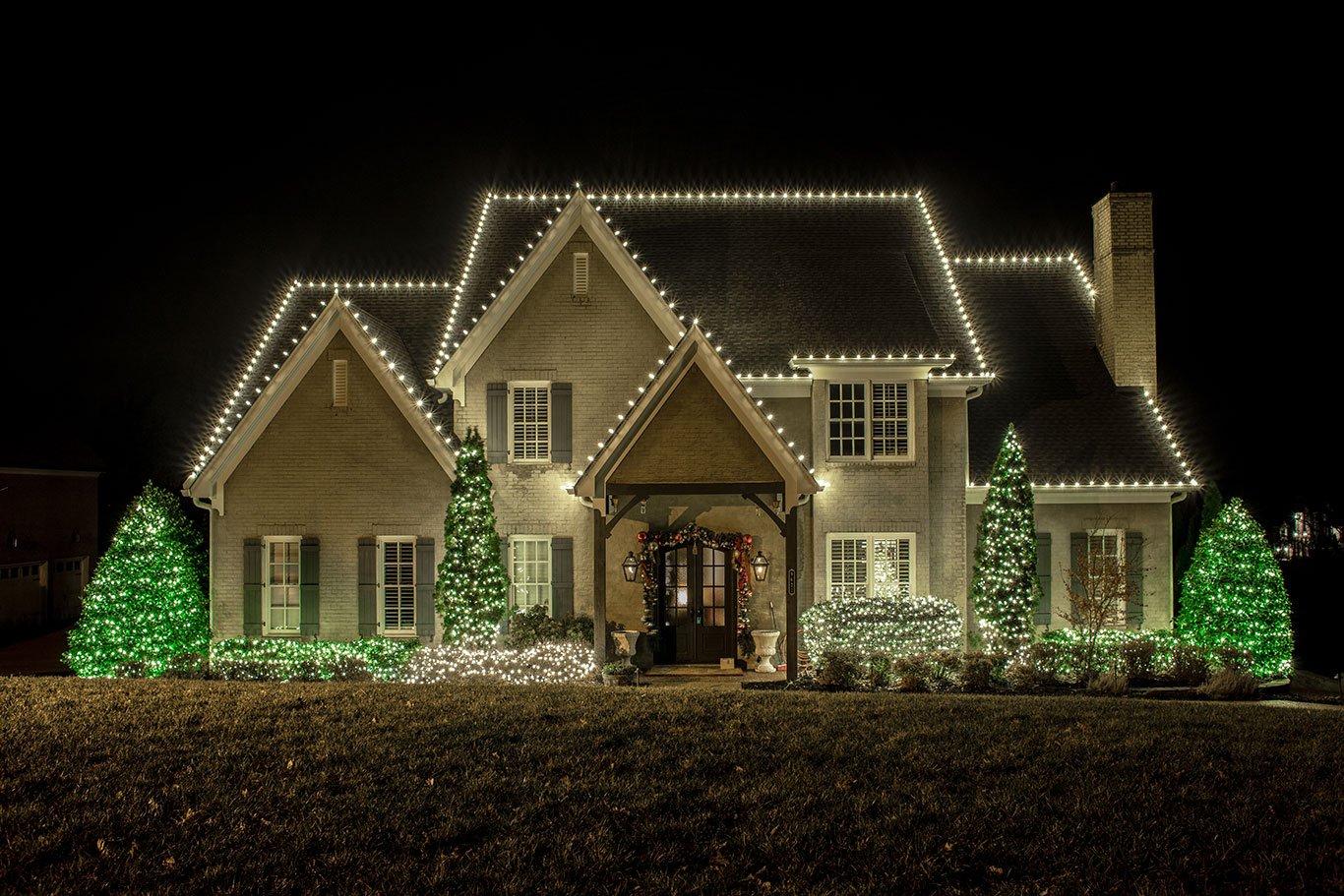 Home professionally decorated with warm white Christmas and permanent LED lighting along the roofline
